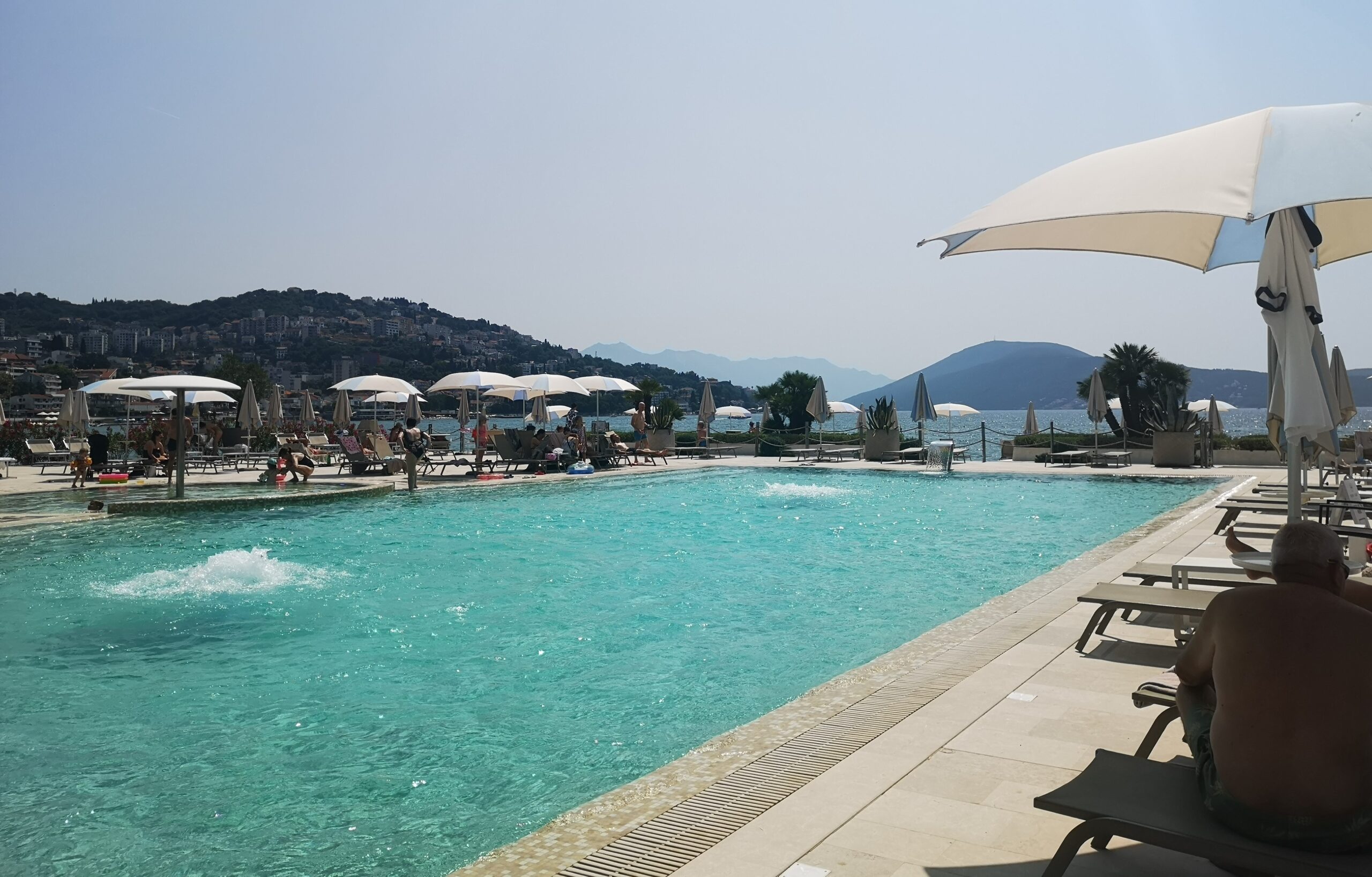 The Palmon Bay Hotel's Beach Club pool, outside area and the mountain scenery.