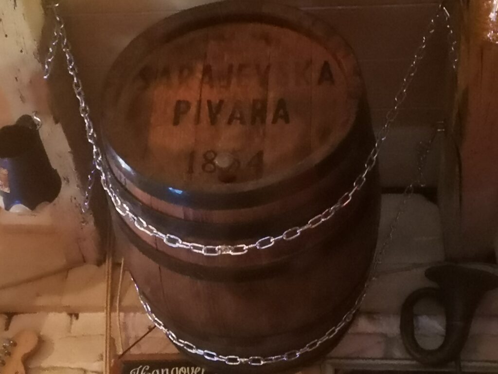 An antique beer barrel hanging from the roof in Pub Got.