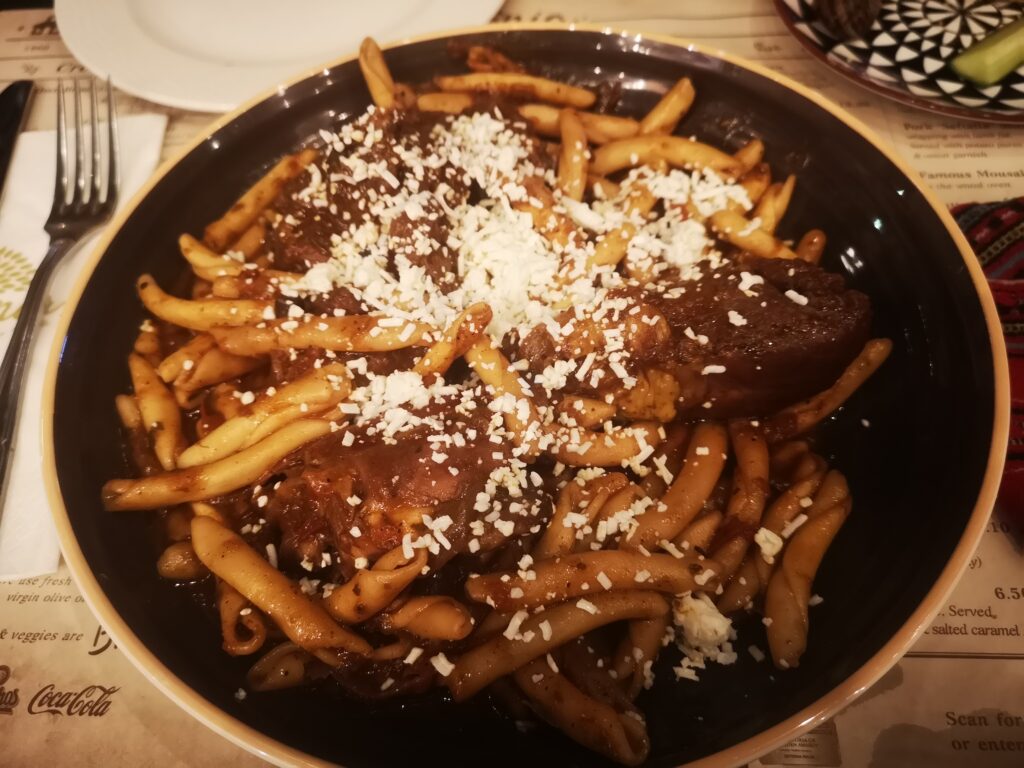 Local dish Rooster with Cretan pasta