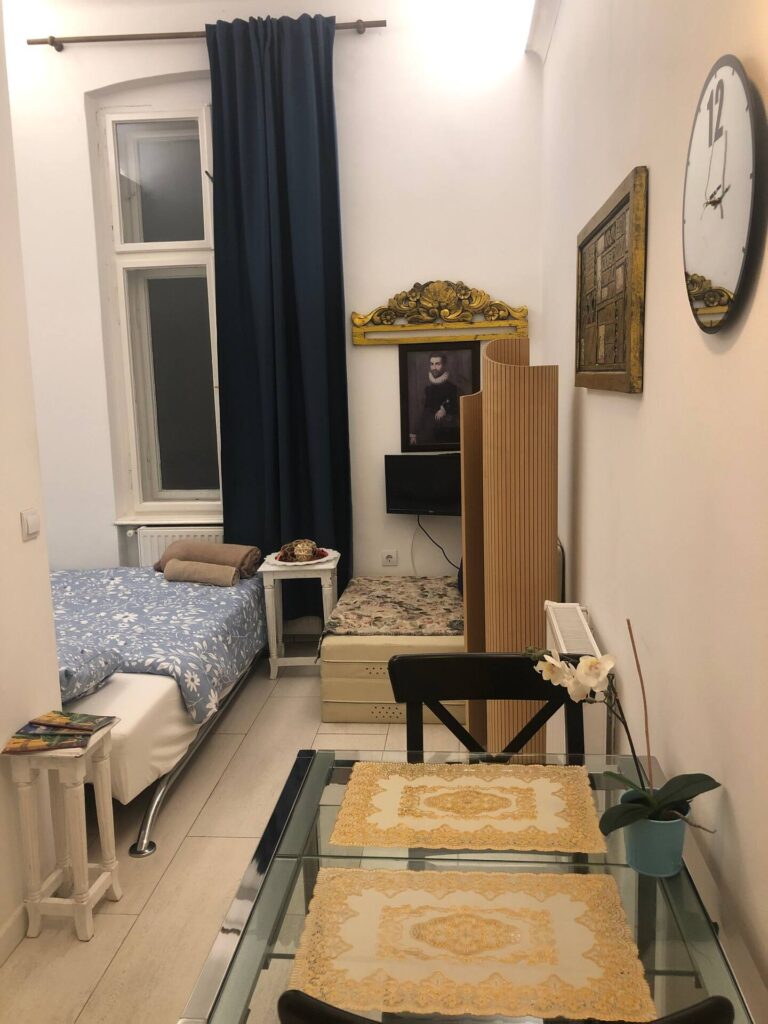 Image showing inside of AirBnB room with TV, Bed, table and chairs and the room decor