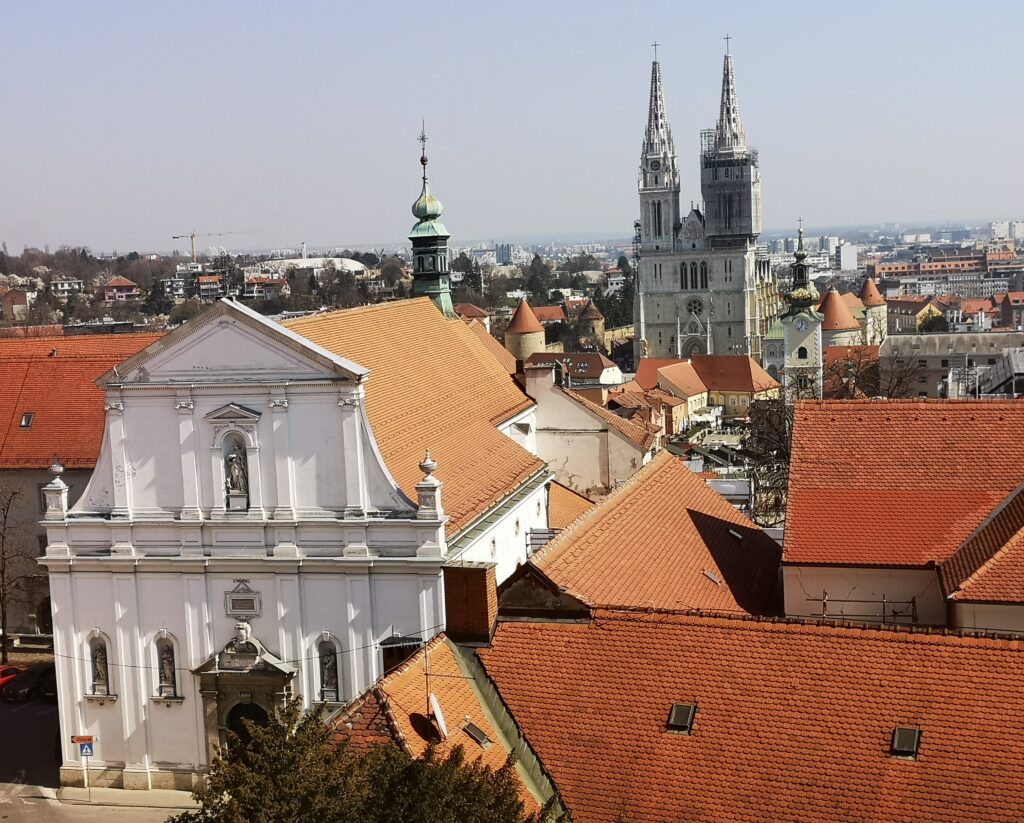 A view of the city landmark Zagreb Cathedral amongst other buildings from the Lotrščak Tower observation platform.