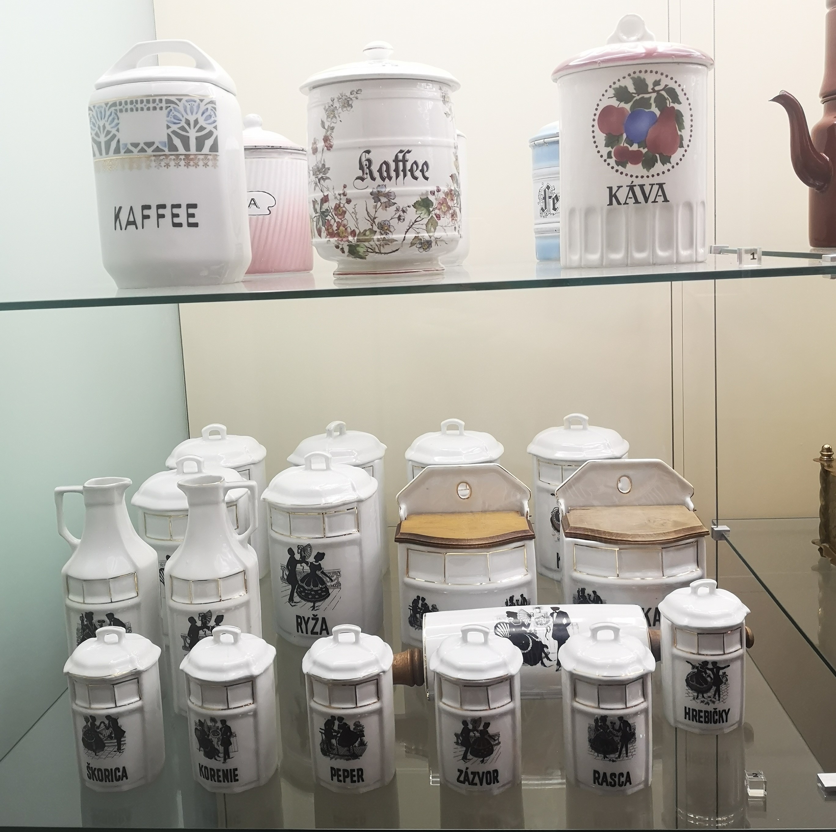Two rows of Slovakian coffe, tea and sugar pots.