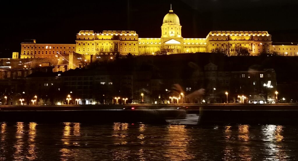Buda castle from the front, all lit up and bright.