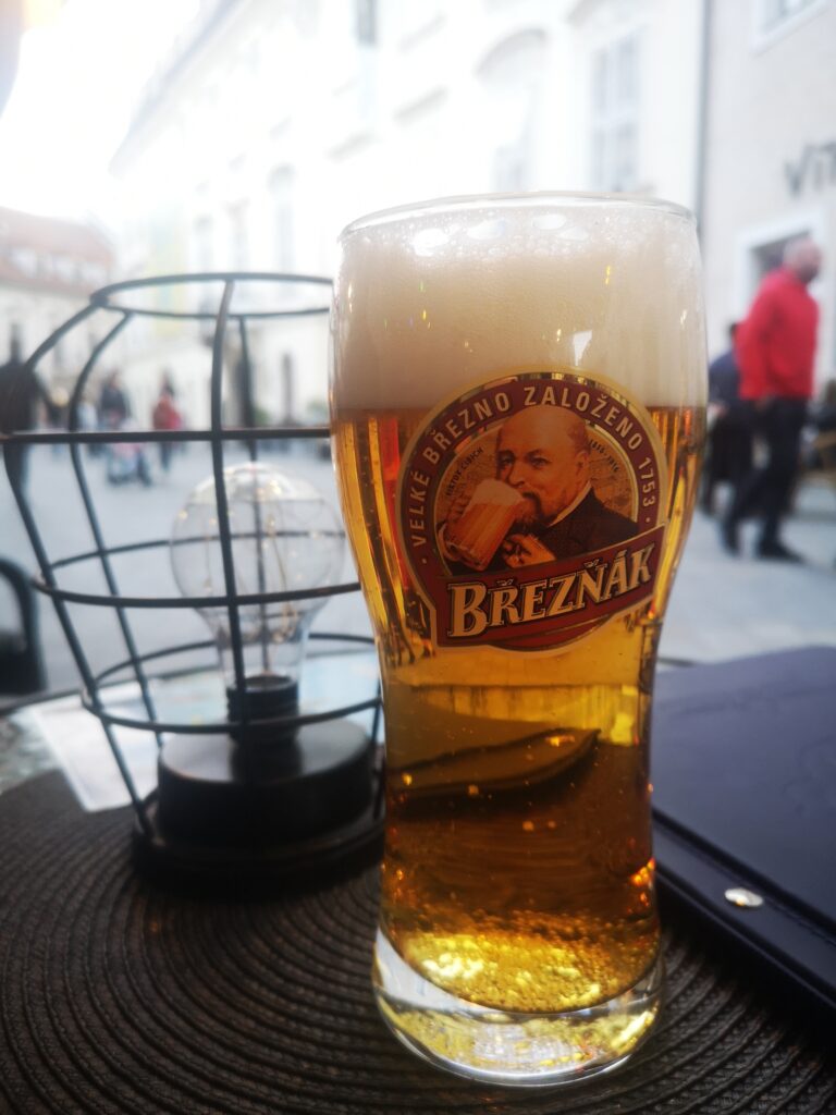 European beer Breznak on a table with a stylish lamp next to it.