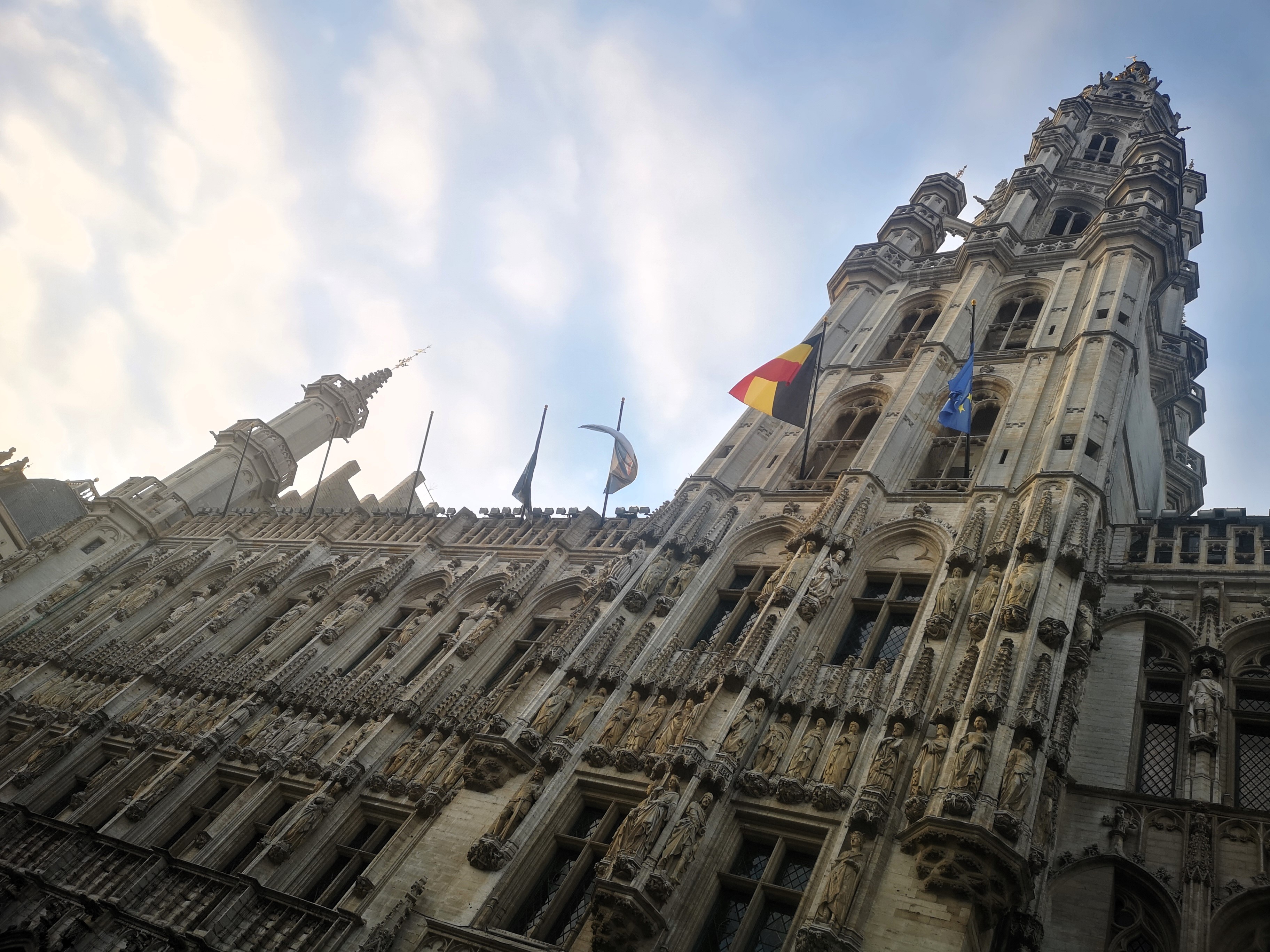 One of Brussels' highlights: The Town Hall from below, complete with a flags flying from the building the Belgian and EU flags in front.