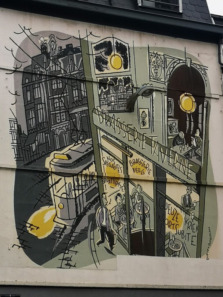 Street art in Brussels: a large mural high on a building showing a bar with Belgian beer