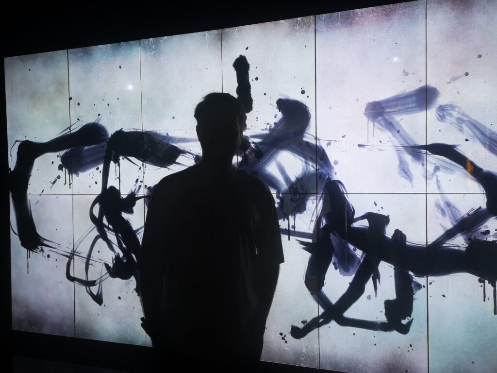 An example of the unique artwork in one of the Top Tokyo Attractions. Black scribbles on a white background, in a graffiti style.